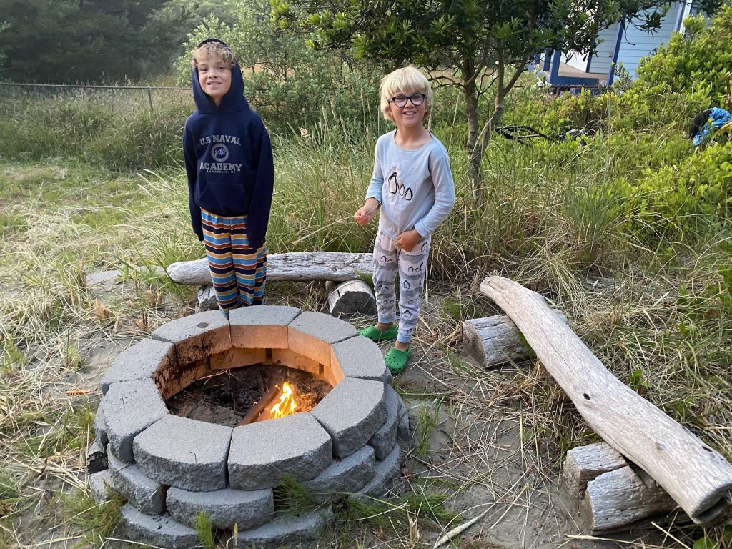 Kids roasting marshmallows campfire in Ocean Shores Washington. 