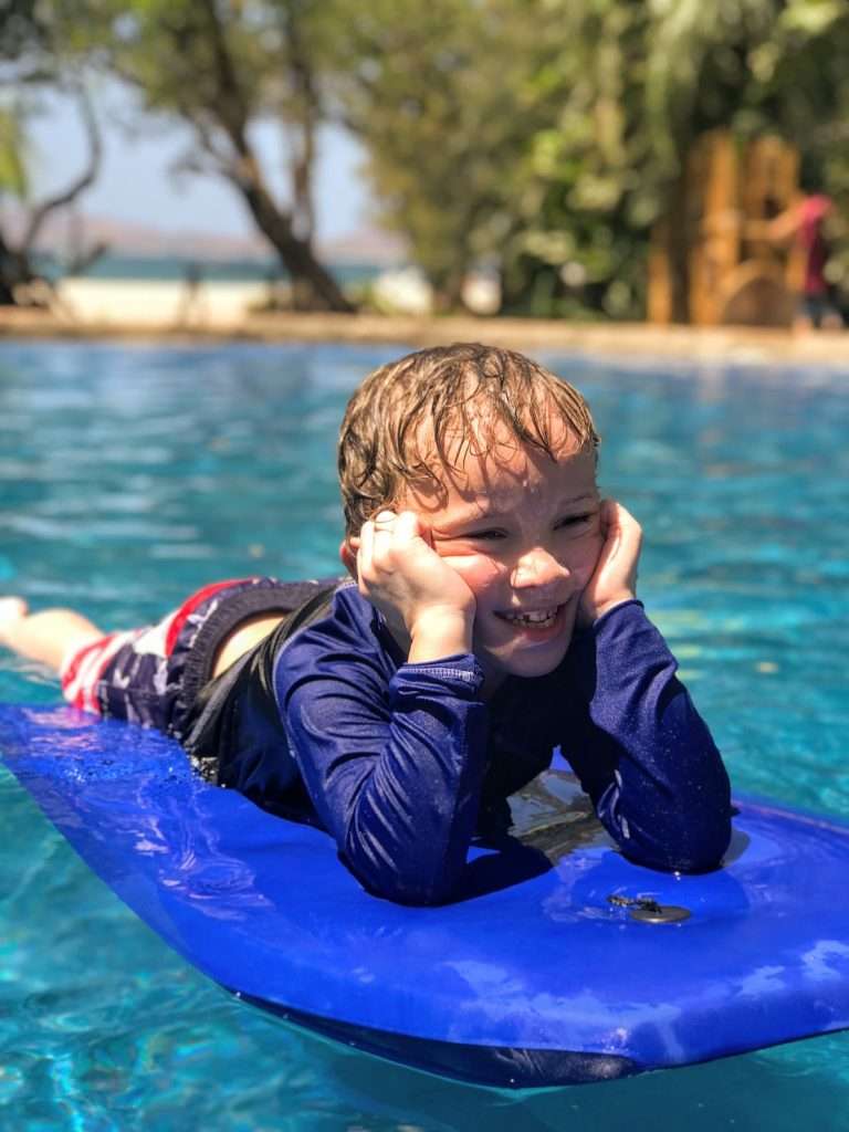 boogie boarding in the pool at Ocho Artisan Bungalows