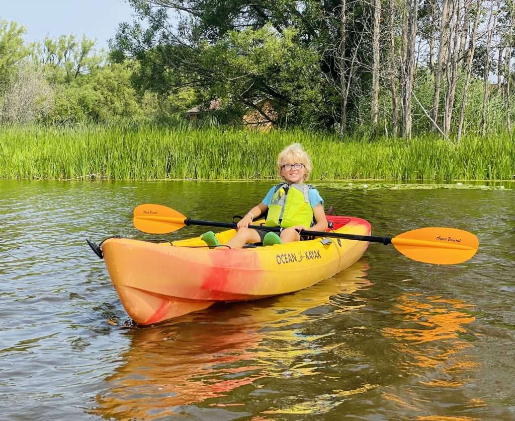 Kayaking down the Ahnapee River in Algoma.