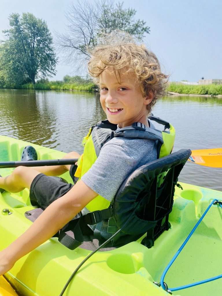 Kayaking down the Ahnapee River in Algoma.